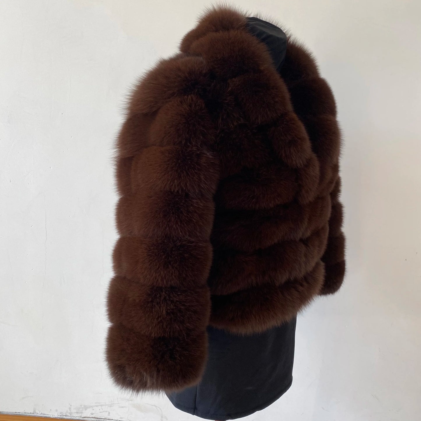 Lady's fashionable warm natural fur coat with a collar for warmth, luxurious high street outerwear