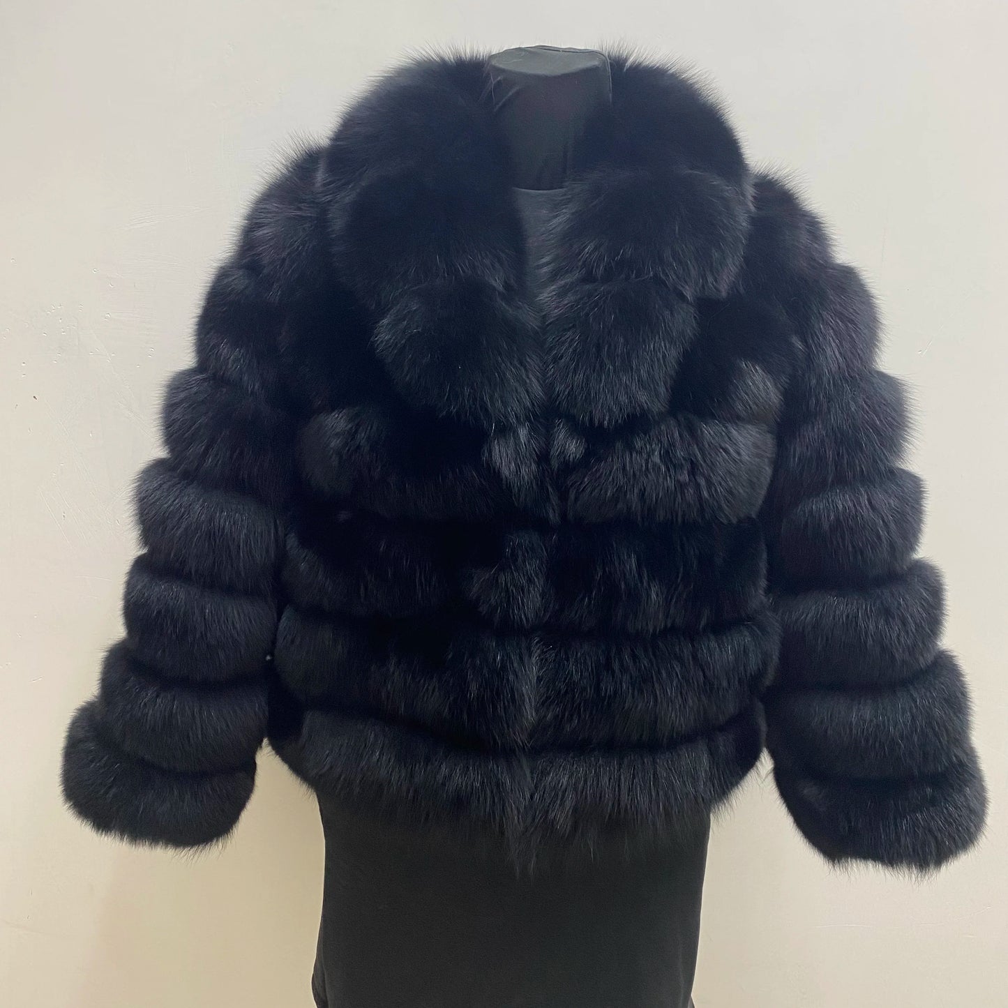 Lady's fashionable warm natural fur coat with a collar for warmth, luxurious high street outerwear