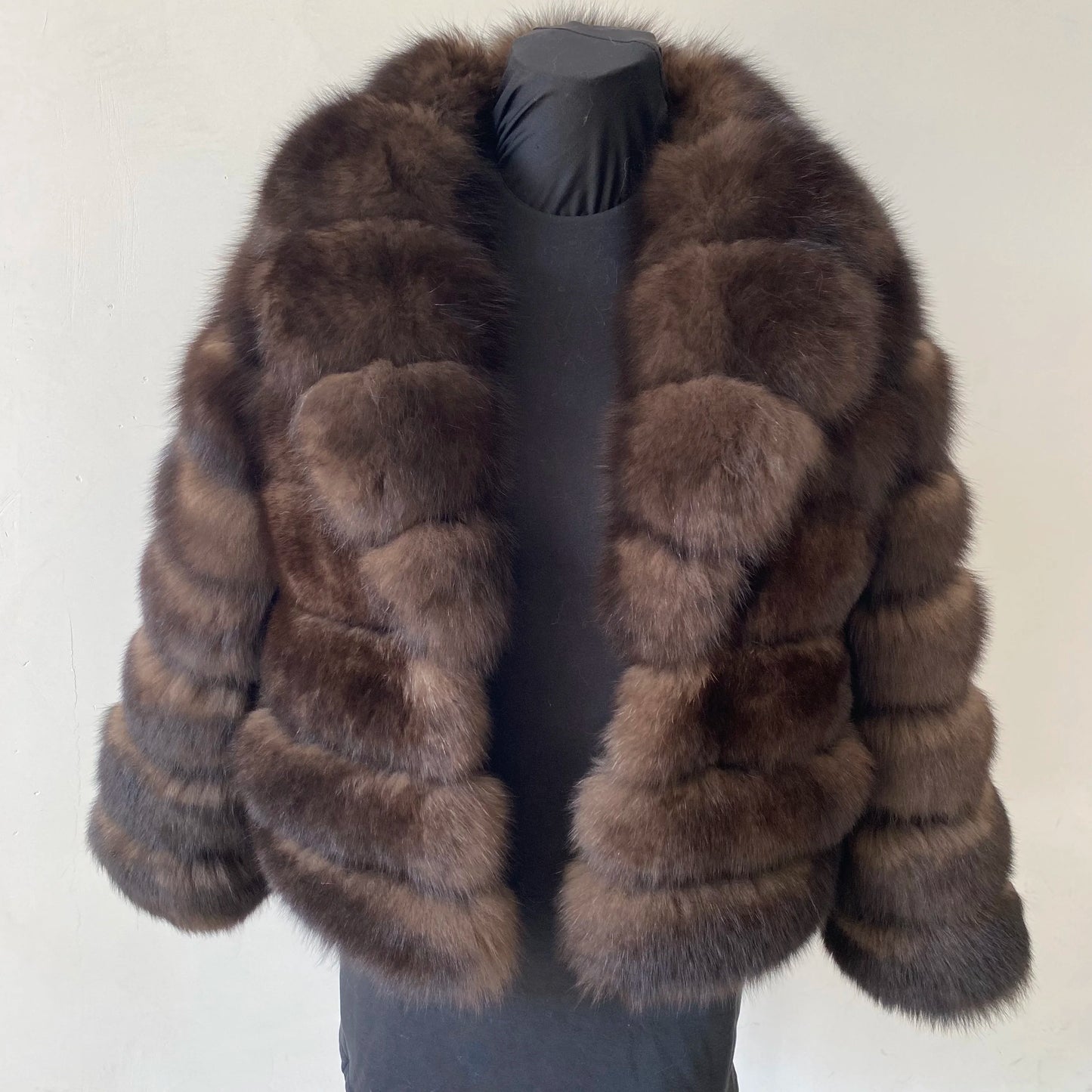 Lady's fashionable warm natural fur coat with a collar for warmth, luxurious high street outerwear