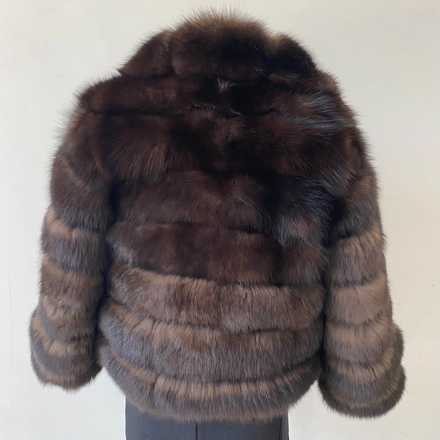 Lady's fashionable warm natural fur coat with a collar for warmth, luxurious high street outerwear