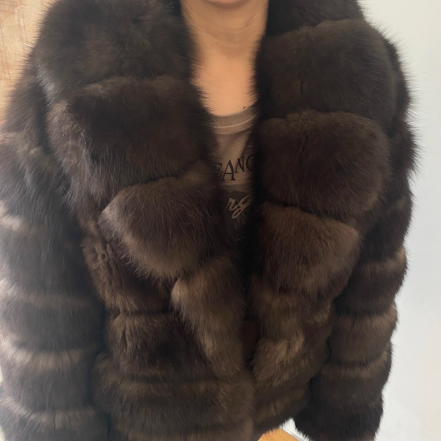 Lady's fashionable warm natural fur coat with a collar for warmth, luxurious high street outerwear