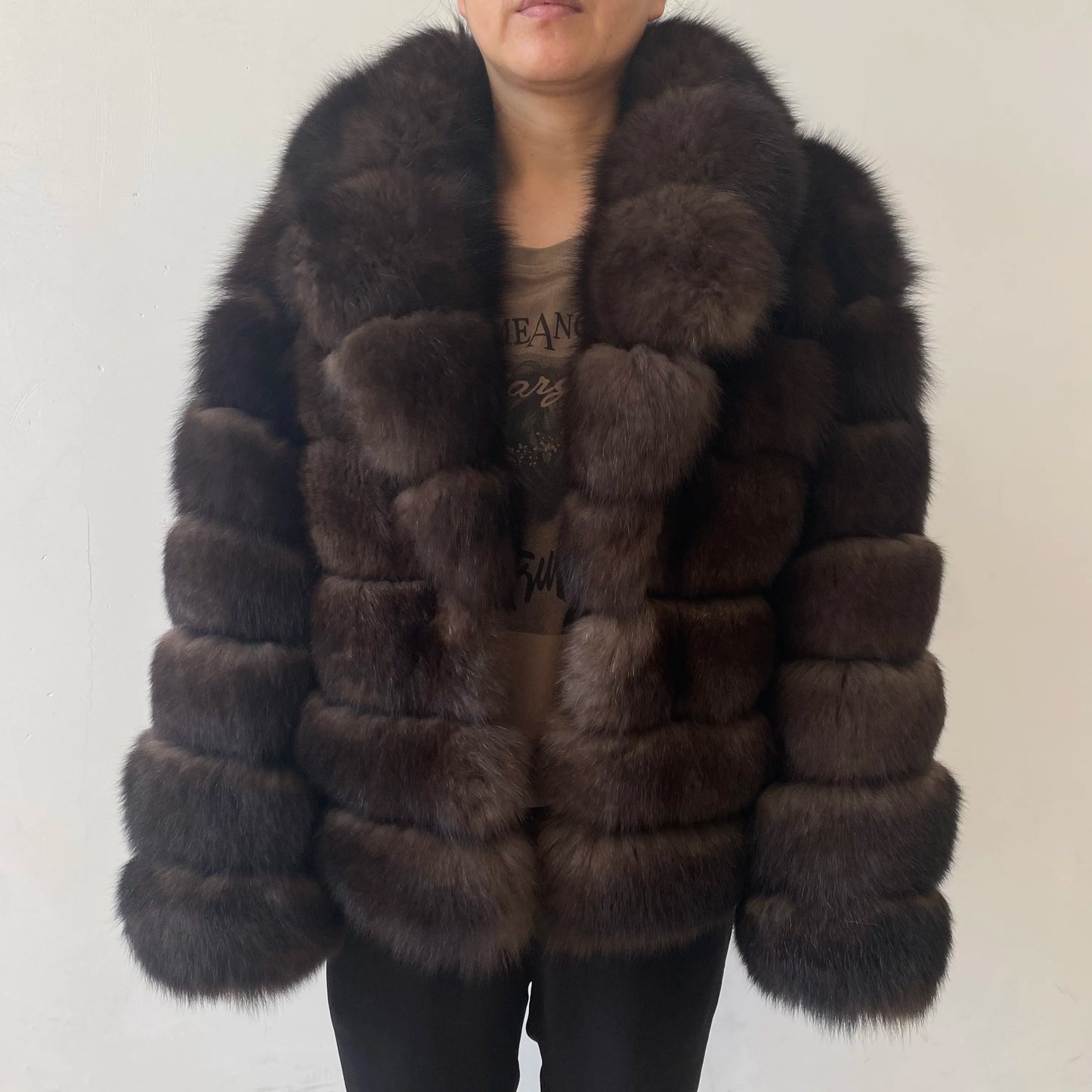 Lady's fashionable warm natural fur coat with a collar for warmth, luxurious high street outerwear