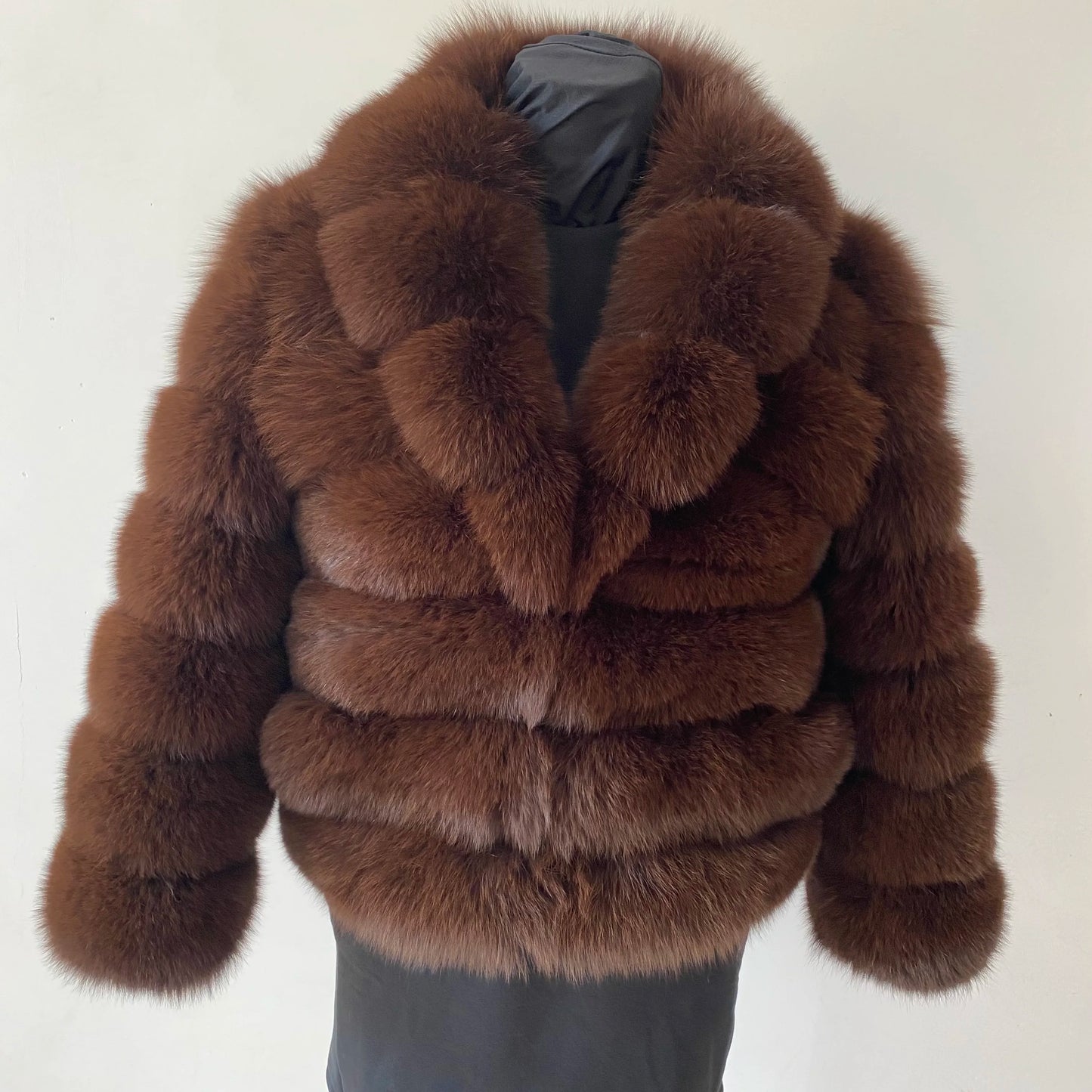 Lady's fashionable warm natural fur coat with a collar for warmth, luxurious high street outerwear