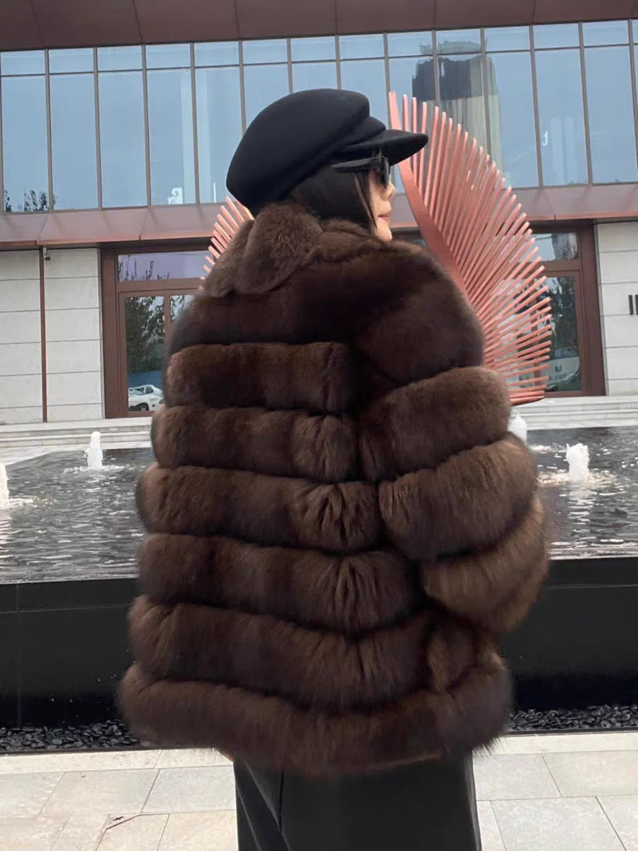Lady's fashionable warm natural fur coat with a collar for warmth, luxurious high street outerwear