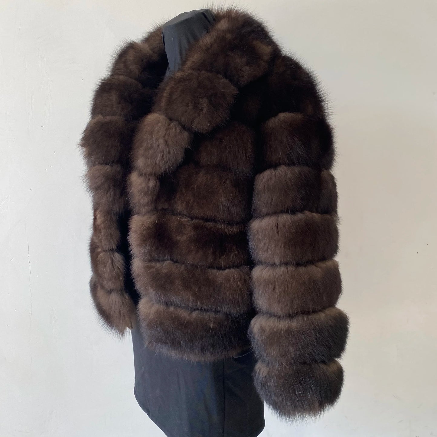 Lady's fashionable warm natural fur coat with a collar for warmth, luxurious high street outerwear