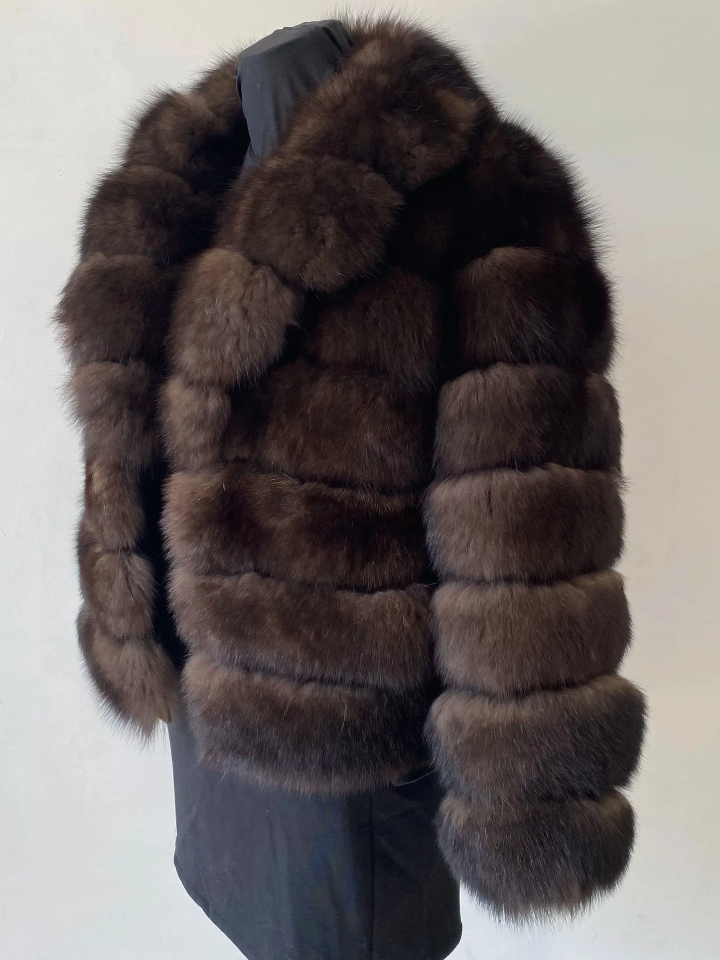 Lady's fashionable warm natural fur coat with a collar for warmth, luxurious high street outerwear